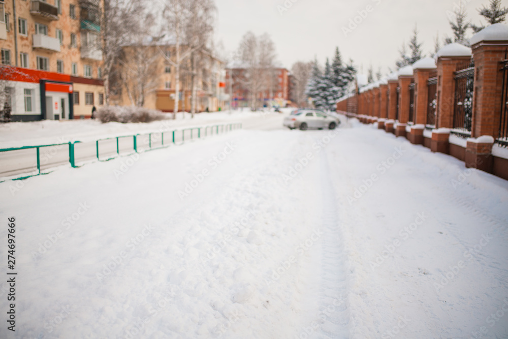 Fototapeta premium metal fence made of bricks. around the snow on the trees. winter day