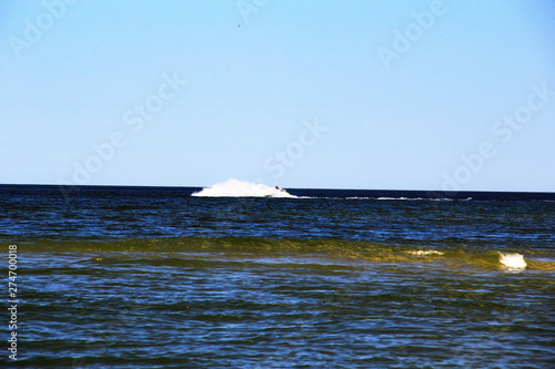 A large wave formed by an athlete on a hydrocycle