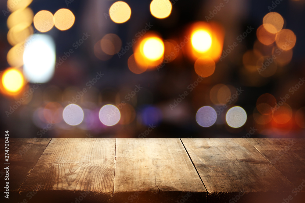 background of wooden table in front of abstract blurred restaurant lights background of wooden table in front of abstract blurred restaurant lights