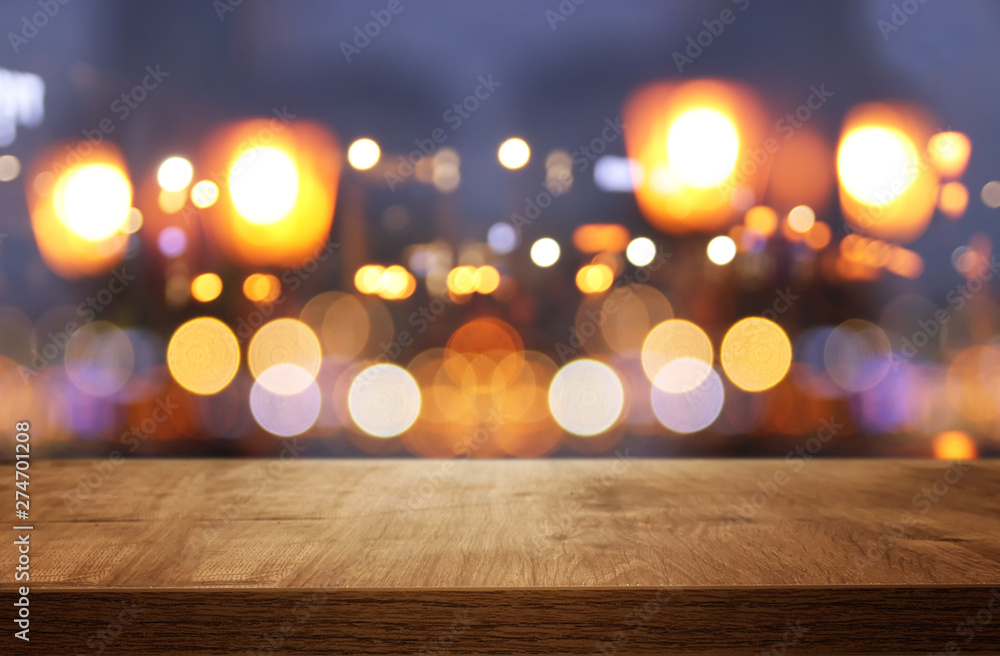 background of wooden table in front of abstract blurred restaurant lights background of wooden table in front of abstract blurred restaurant lights