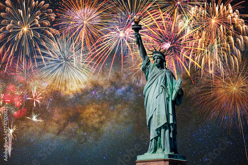 Statue of Liberty over the Multicolor Fireworks Celebrate with the milky way background, 4th of July and Independence day concept