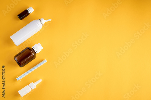 Nasal spray bottle composition, white template bottle on yellow background