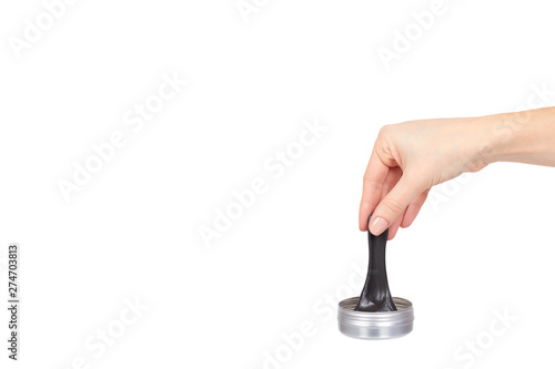 Teenager playing black slime with hand, transparent toy