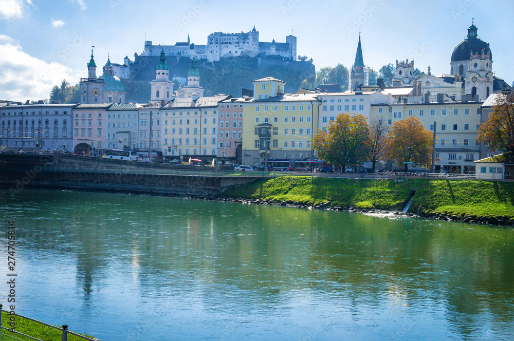 View to river quay and colorful buildings with fortress background in Salzburg Austria at autumn