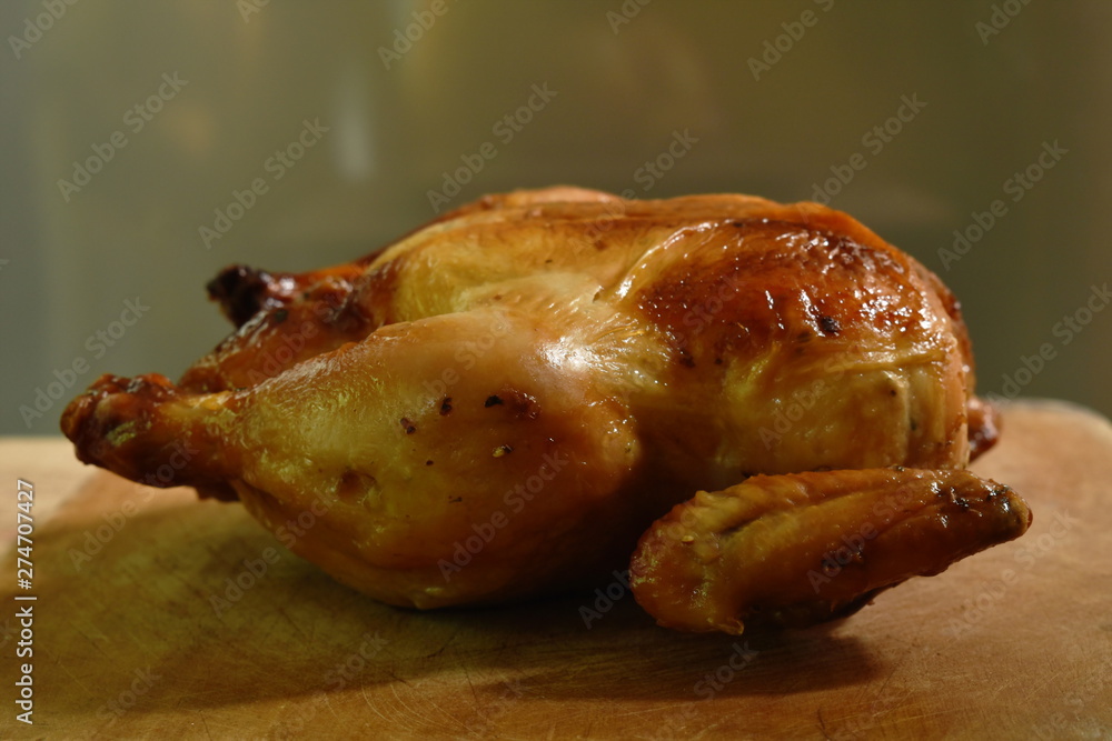 grilled chicken with sweet sauce on wooden chop block in home kitchen grilled chicken with sweet sauce on wooden chop block in home kitchen