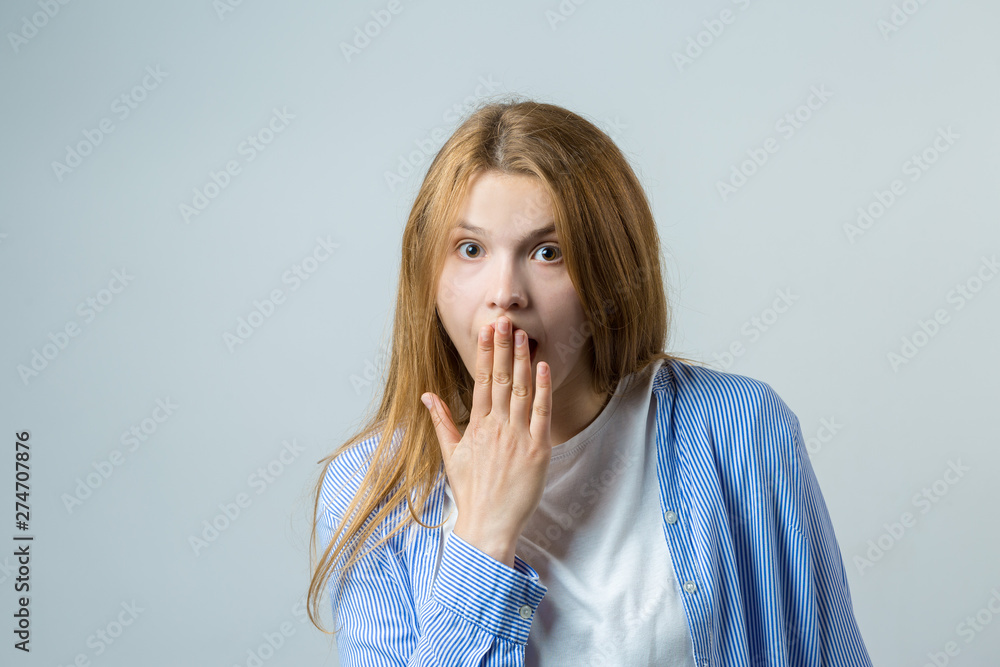 Emotional portrait of a red-haired girl on a gray background, stormy emotions, business concept. Emotional portrait of a red-haired girl on a gray background, stormy emotions, business concept.