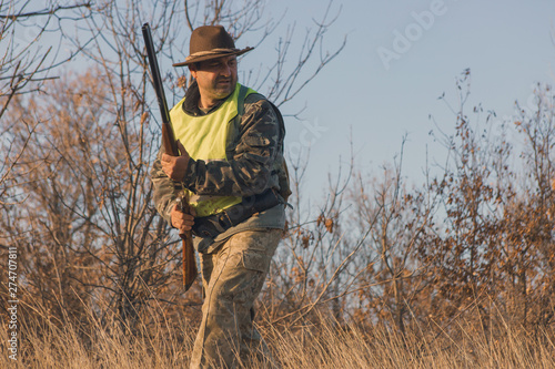 Hunters with a german drathaar and spaniel, pigeon hunting with dogs in reflective vests 