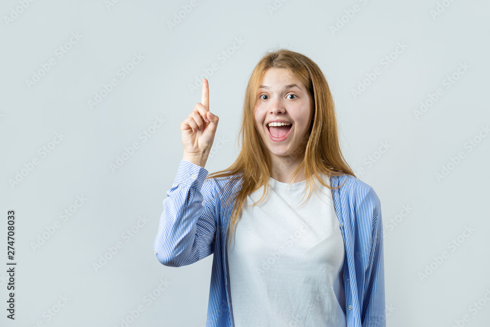 Emotional portrait of a red-haired girl on a gray background, stormy emotions, business concept. Emotional portrait of a red-haired girl on a gray background, stormy emotions, business concept.