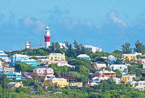 Tableau sur toile Bright pastel colored homes dot the hillside in Bermuda with a red and white lighthouse on the top