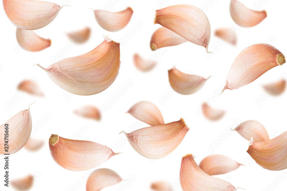 Falling garlic, isolated on white background, selective focus
