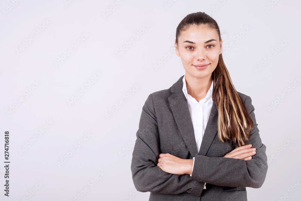 young woman standing over grey grunge wall crazy and mad shouting and yelling with aggressive expression and arms raised. Frustration young woman standing over grey grunge wall crazy and mad shouting and yelling with aggressive expression and arms raised. Frustration
