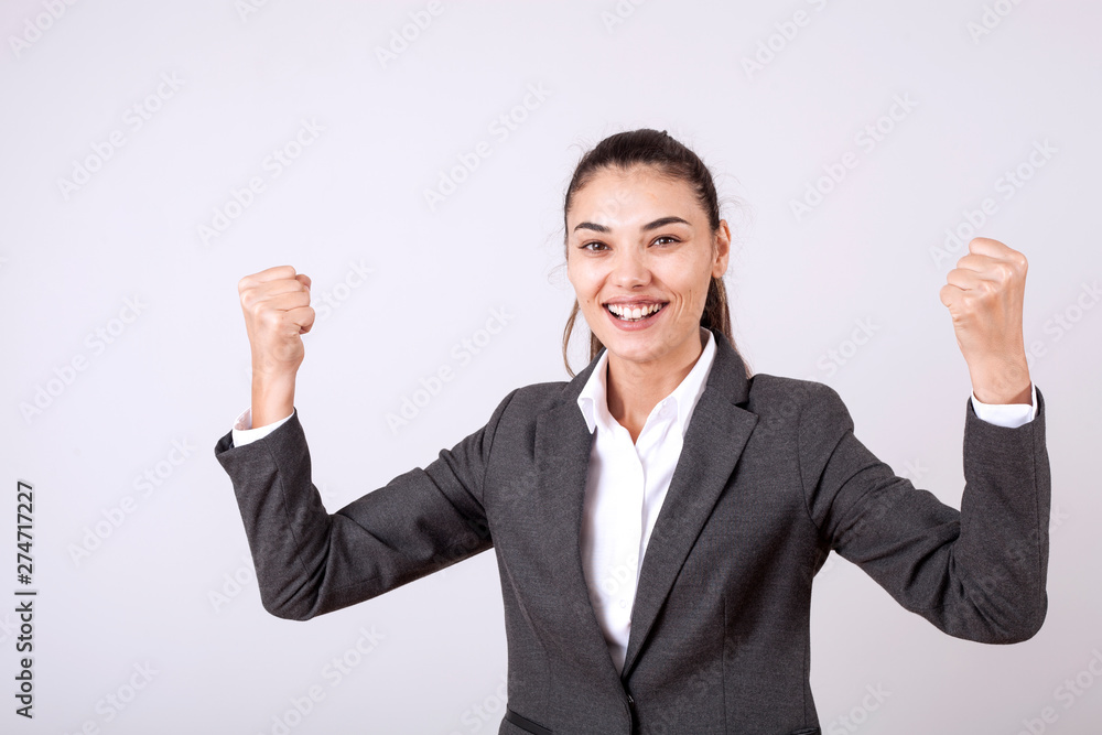 young woman standing over grey grunge wall crazy and mad shouting and yelling with aggressive expression and arms raised. Frustration young woman standing over grey grunge wall crazy and mad shouting and yelling with aggressive expression and arms raised. Frustration