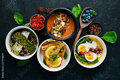 Food with delivery. A set of dishes for the diet. Top view. Free space for your text. On a black background.