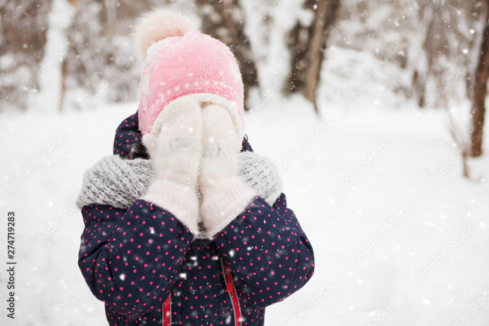 Funny baby laughing outdoors in winter day