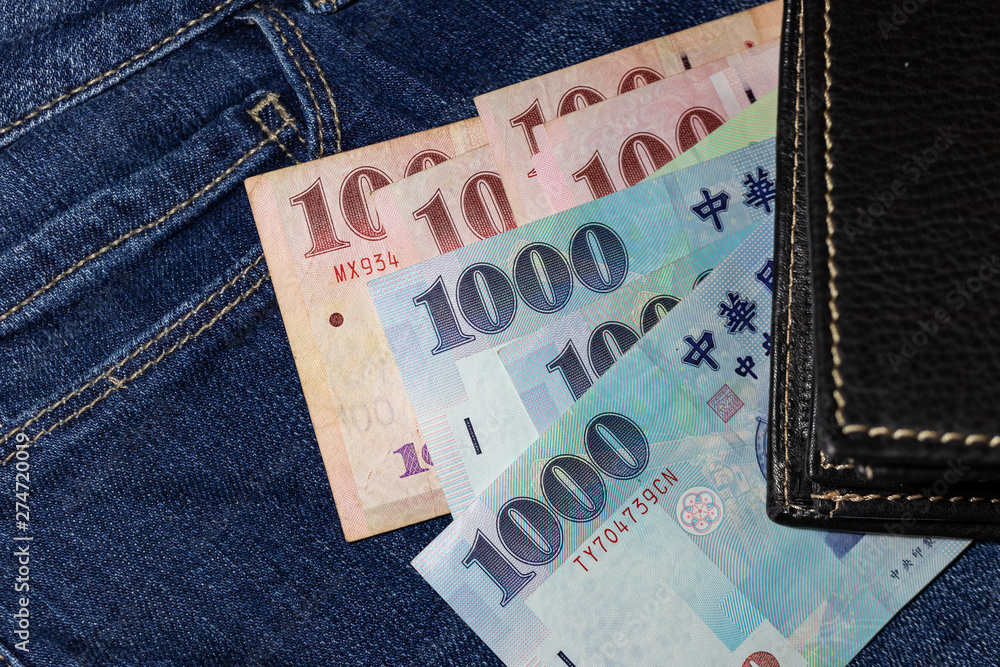Obraz premium Taiwanese money, Taiwan Banknote, Taiwan dollar on jean background.