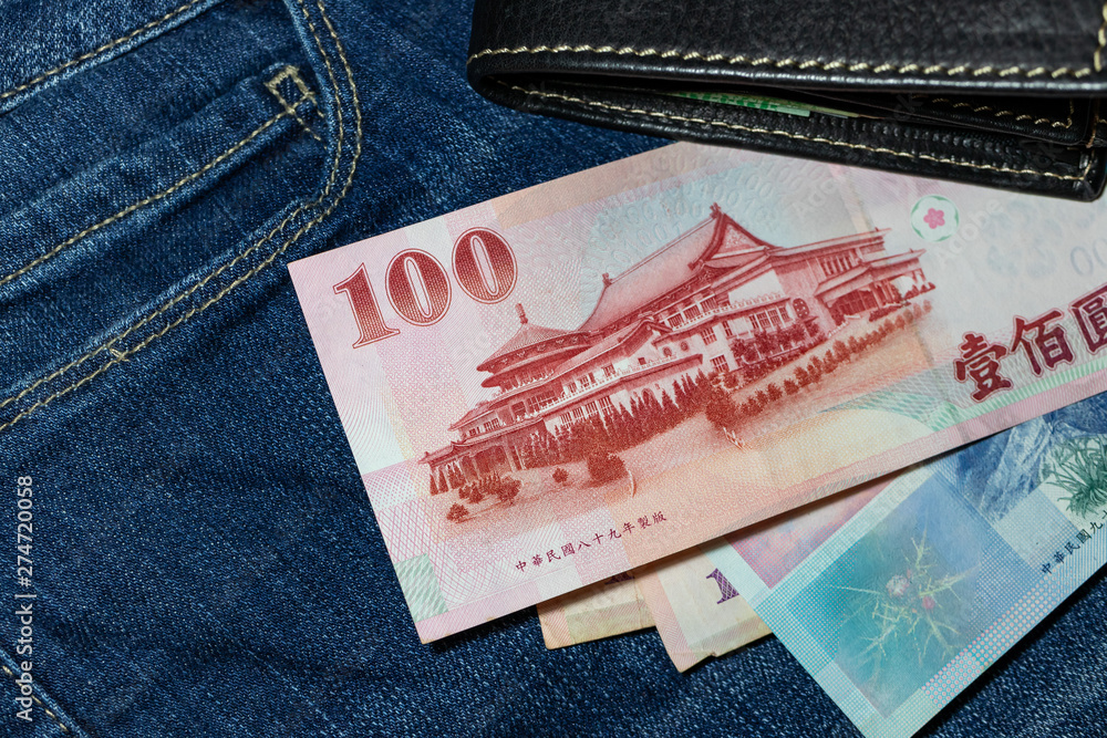 Obraz premium Taiwanese money, Taiwan Banknote, Taiwan dollar on jean background.