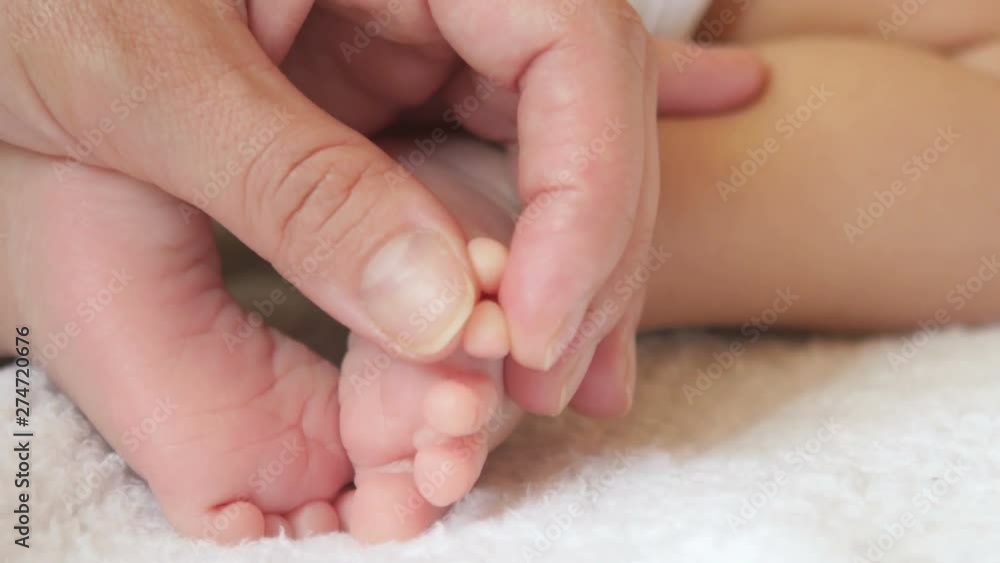 mother gently touches the fingers of her baby, motherhood mother gently touches the fingers of her baby, motherhood