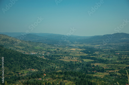 Wooded valley with the roofs of a small village