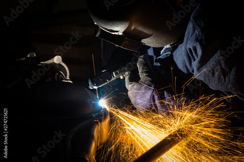 Workers are grooving with carbon welding wires With sparksWorkers are grooving with carbon welding wires With sparks
