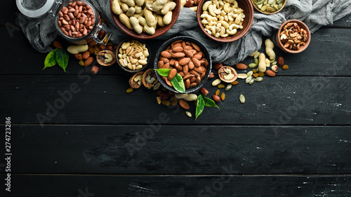 Assorted nuts on the old black background. Top view. Free space for your text. photo