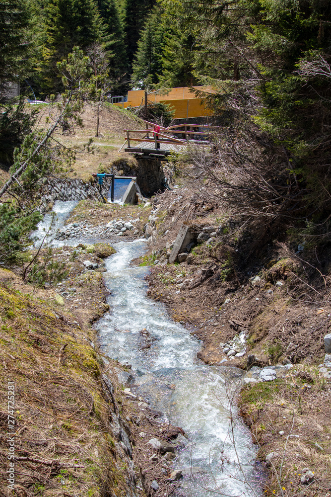 View of waterfalls and mountain streams with a lot of melt water in spring in the swiss alps