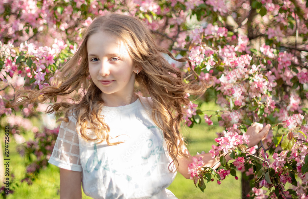 candid portrait of a girl in a blooming apple orchard candid portrait of a girl in a blooming apple orchard
