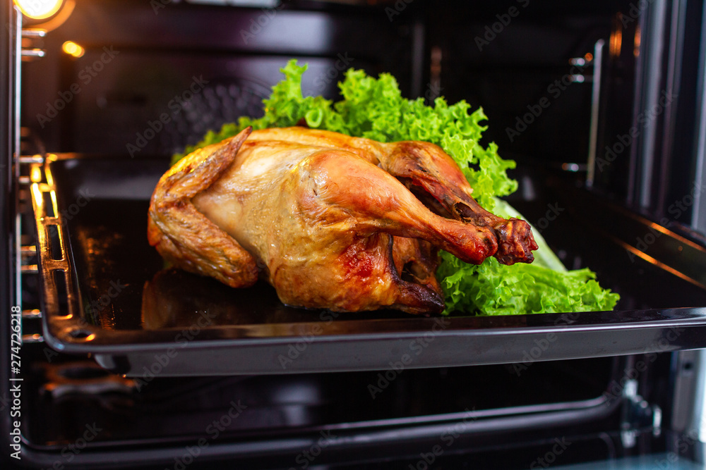 Baked homemade chicken with vegetables close up in the oven for dinner at home. Baked homemade chicken with vegetables close up in the oven for dinner at home.