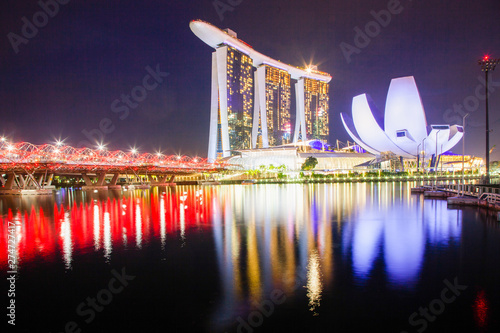 SINGAPORE, SINGAPORE - MARCH 2019: Skyline of Singapore Marina Bay at night with Marina Bay sands and Art Science museum reflecting in a pond after rain. Vibrant night scene