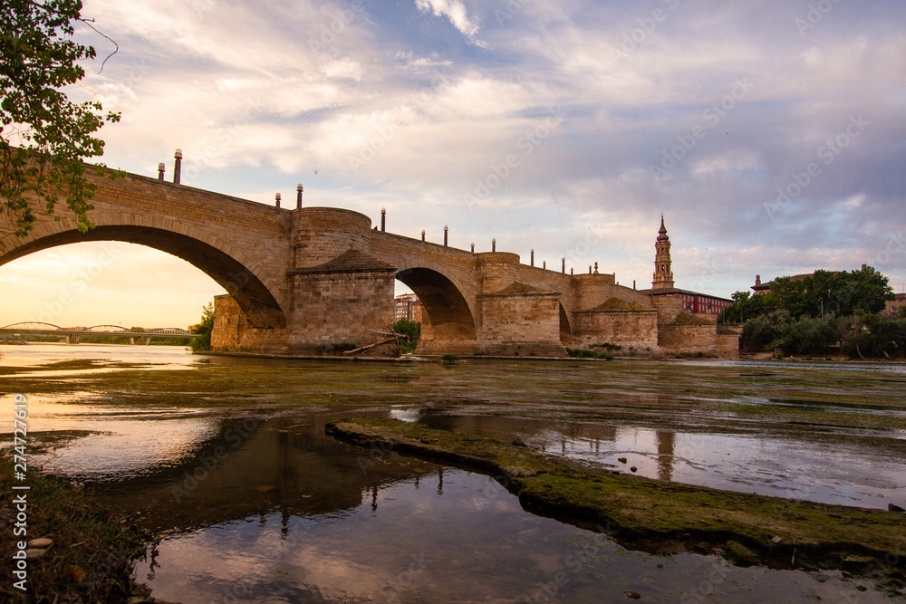 Ebro river passing through Zaragoza city in front of the stone bridge