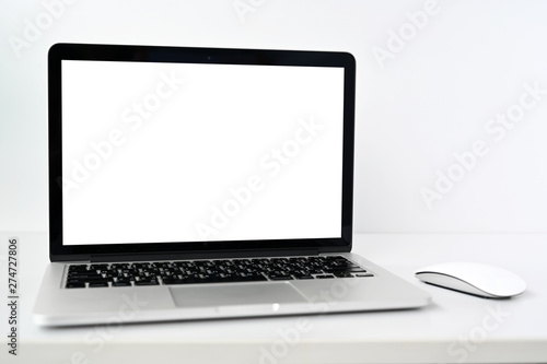 Mockup blank screen Modern laptop computer with mouse on table in office view backgrounds