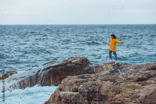 woman enjoying storm weather at sea