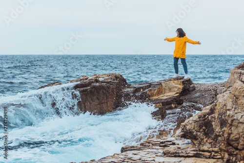 woman enjoying storm weather at sea