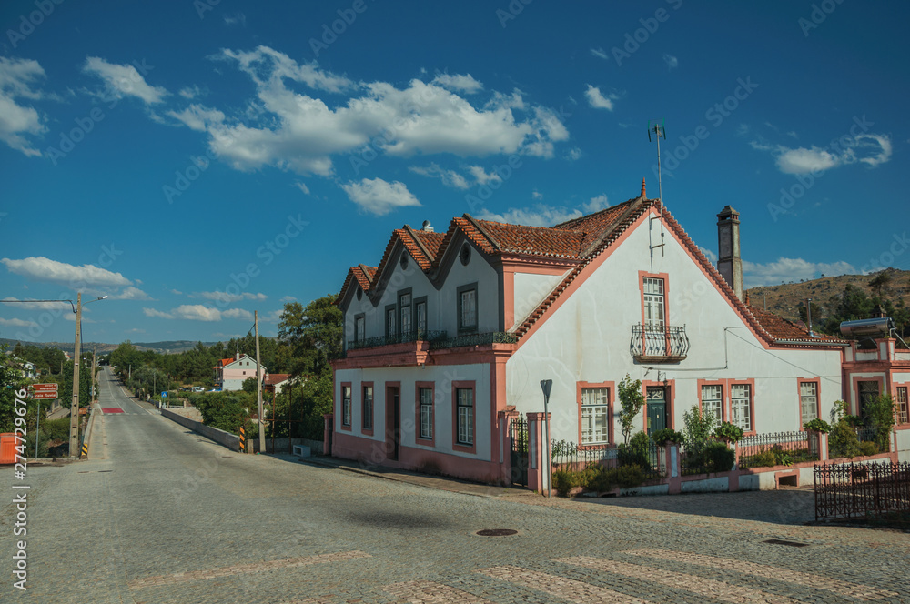 House next to a road passing through countryside House next to a road passing through countryside