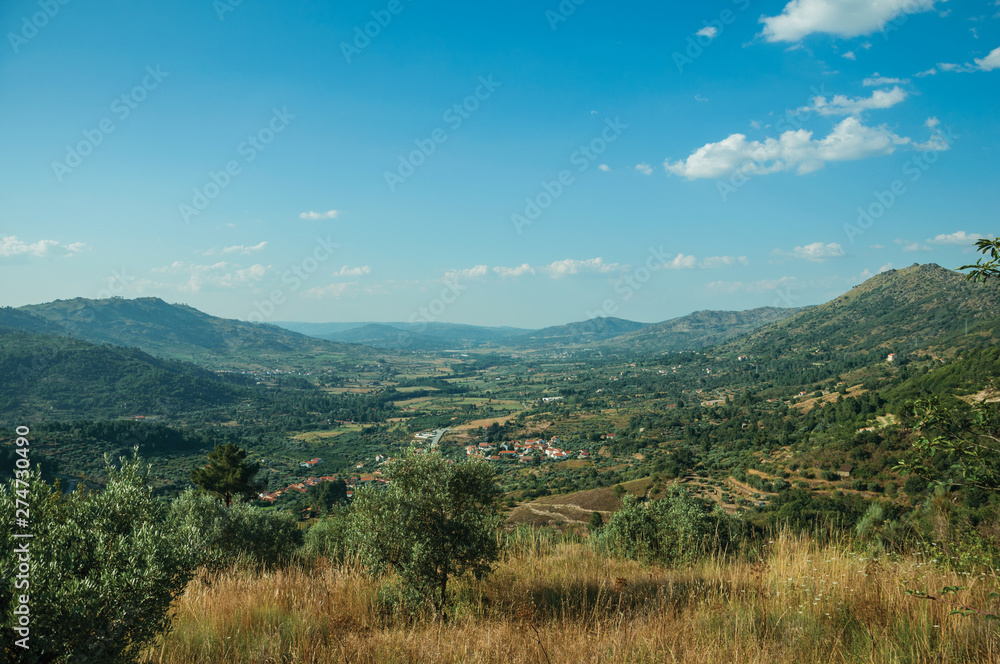 Valley with the roofs of a small village underneath