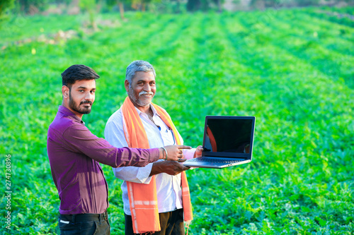indian agronomist with farmer at field