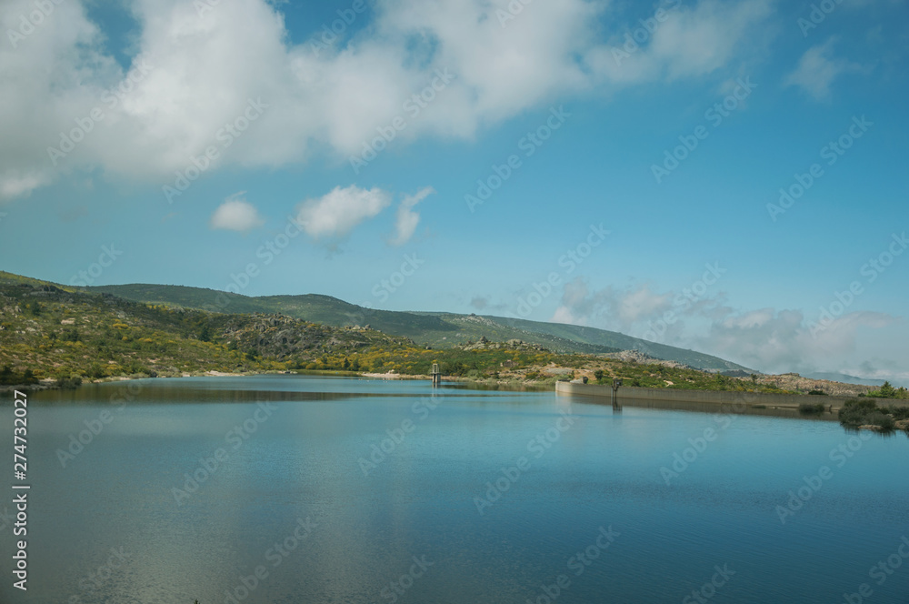 Blue water at the Rossim Lake with dam