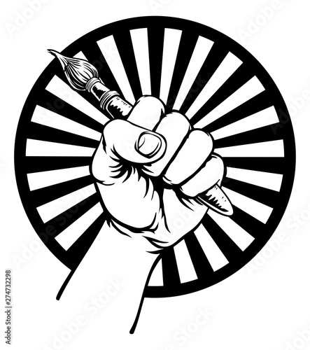 A fist hand holding an artists paintbrush in a vintage intaglio woodcut engraved or retro propaganda style