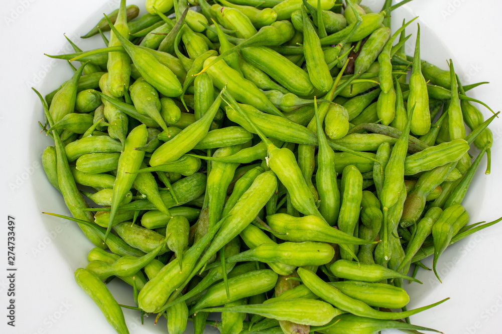 Radish seed pods on a white plate. Radish seed pods on a white plate.