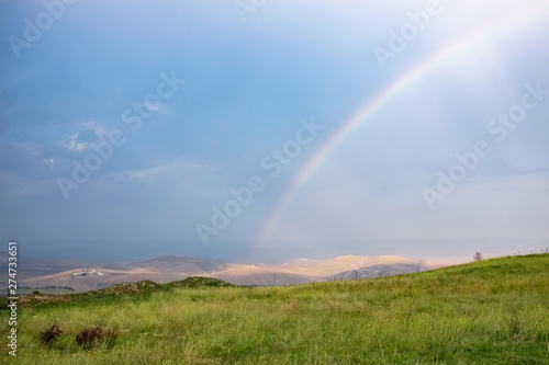 Wonderful landscape view over Basilicata countryside on a stormy day with a rainbow. Monteserico castle, Italy © effebi77