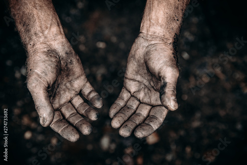 Dirty hands of worker miner are corns palms in abrasions. Concept hard work photo