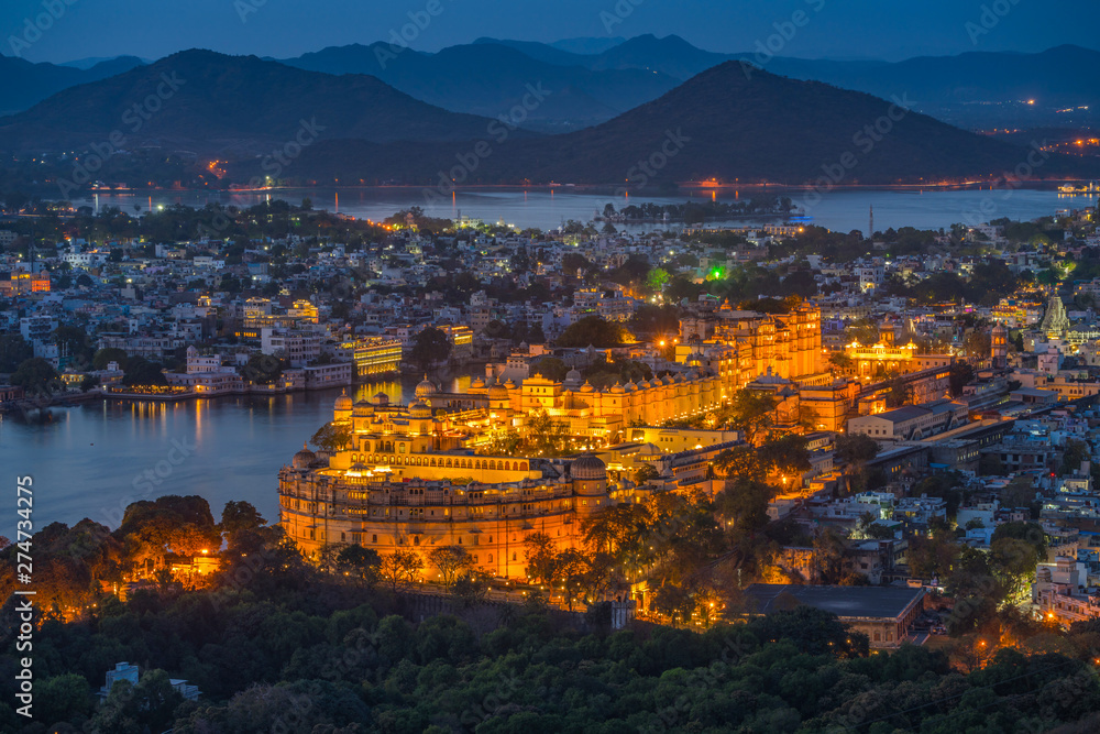 Aerial view of City Palace after sunset. Udaipur, Rajasthan, India