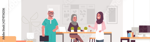 arab businesspeople discussing new business project during meeting arabic colleagues working together brainstorming successful teamwork concept modern office interior portrait horizontal