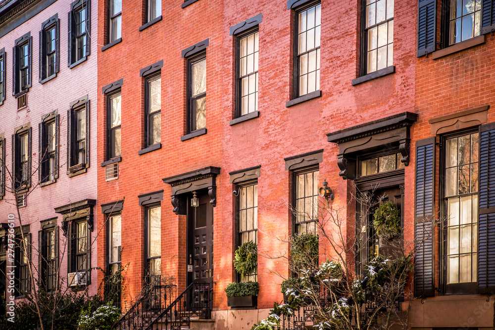 Fototapeta premium Row of lovely brick and brownstone New York City apartments seen from outside.