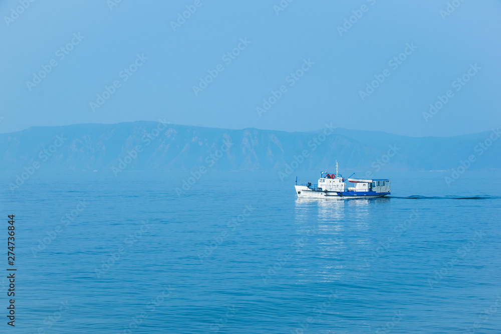 The white ship sails on lake Baikal on a Sunny day. The white ship sails on lake Baikal on a Sunny day.