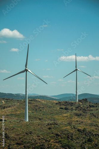 Wind turbines over hilly landscape