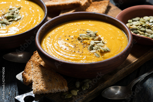 Fotografie, Obraz Delicious pumpkin soup on wooden table, closeup