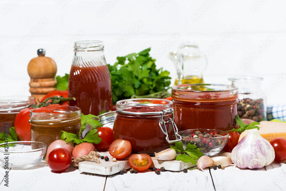 tomato sauces, pasta and fresh ingredients on white wooden table, closeup tomato sauces, pasta and fresh ingredients on white wooden table, closeup