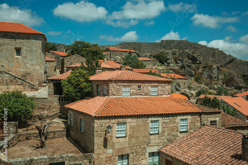 Rooftops of old houses and large wall
