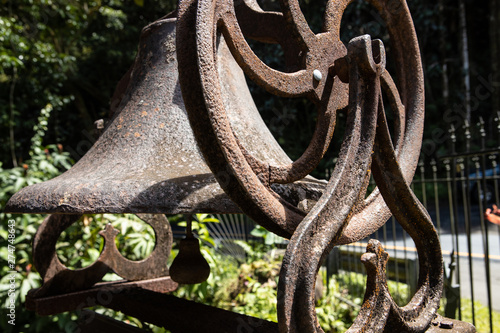 A weathered and rusty iron bell