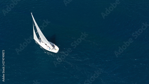 Aerial drone photo of sail boat cruising the deep blue Aegean sea, Greece © aerial-drone
